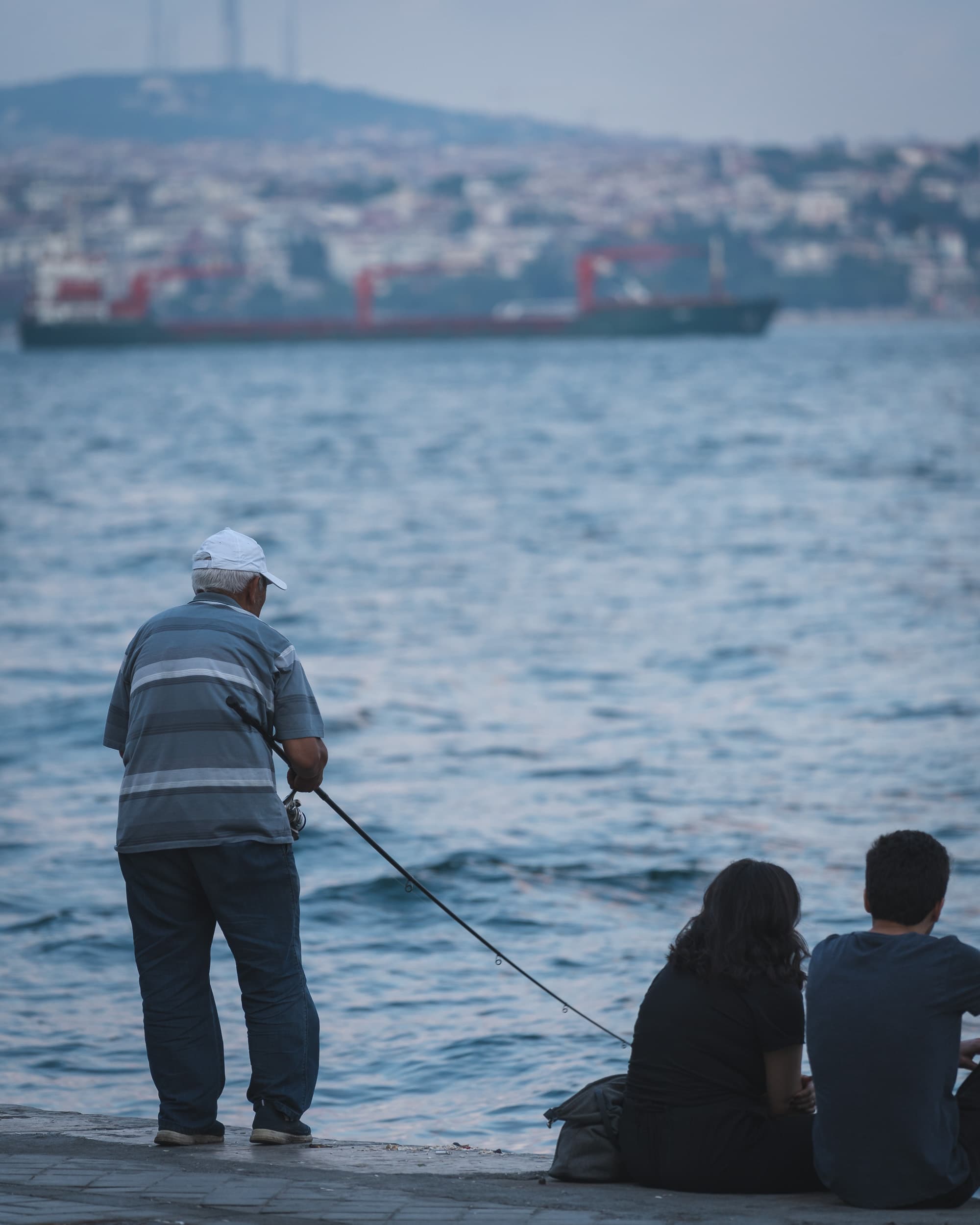 old man fishing in Istanbul old man fishing in Istanbul