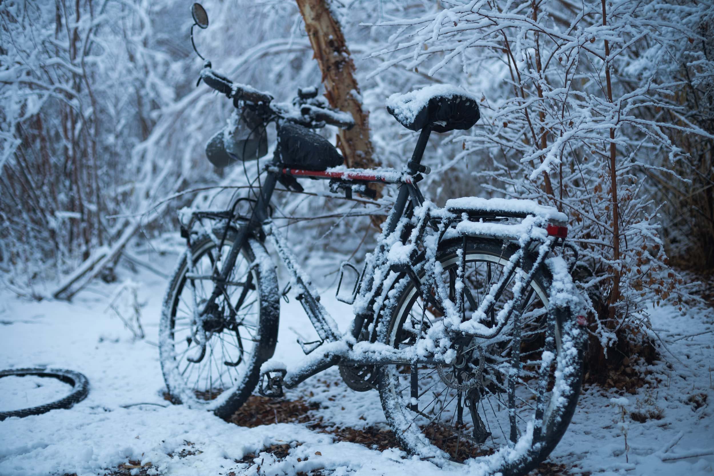Snow covered touring bicycle Bartang Valley Snow covered touring bicycle Bartang Valley